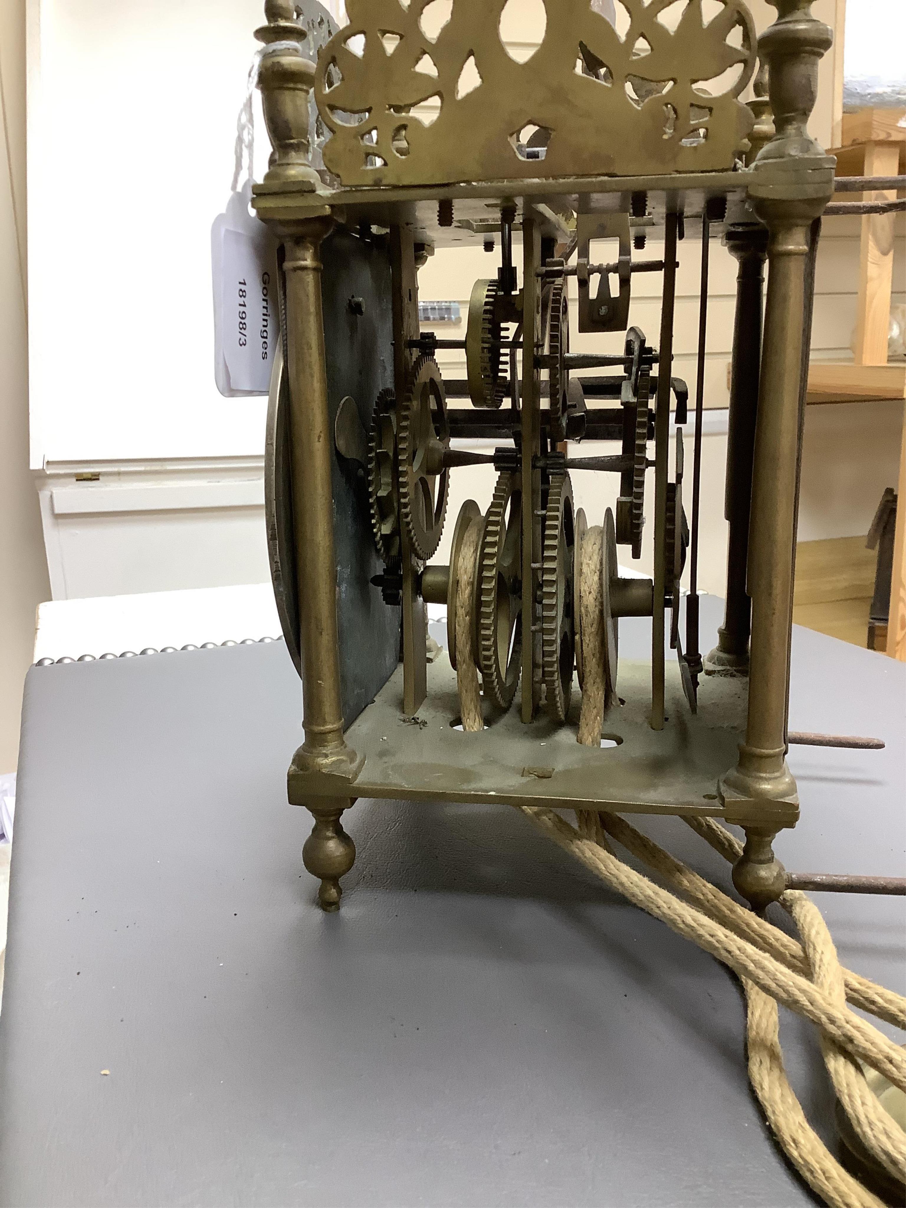 R. Arnold, Bodmin, a lantern clock on wooden wall shelf, clock 32cm high
